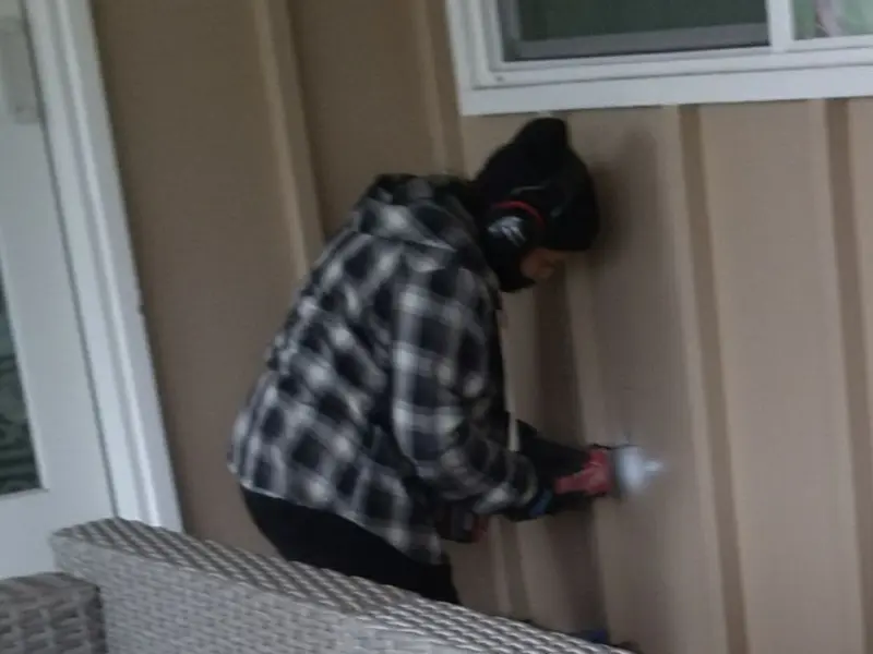 Professional electrician installing an exterior outlet in Braidwood